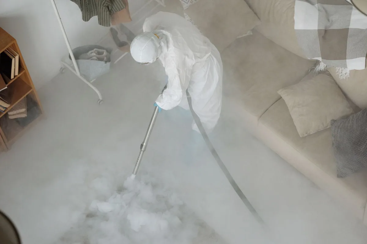 Biohazard cleanup technician in protective equipment, Clyde, NY